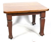 An early 20th century mahogany square top dining table.