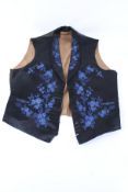 A 19th century gentleman's embroidered silk evening waistcoat. With blue floral decoration.