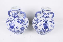 A pair of contemporary blue and white twin handle vases. With floral decoration.
