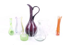 Seven pieces of glassware. Including vases and a large white and purple jug.