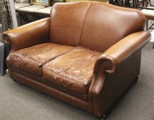A vintage Laura Ashley two seater brown leather sofa.