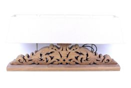 A modern carved wooden table lamp.