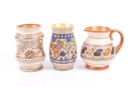 Three Charlotte Rhead for Crown Ducal pottery items. Comprising two vases and a jug. Max. H17.