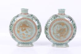 A pair of 20th century Chinese seladon ground moon flasks.