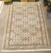 A contemporary Persian style wool pink, blue and cream rug.