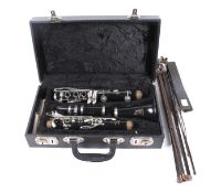 A Boosey & Hawkes Regent clarinet with fitted case and a music stand. Clarinet S/N 490264.