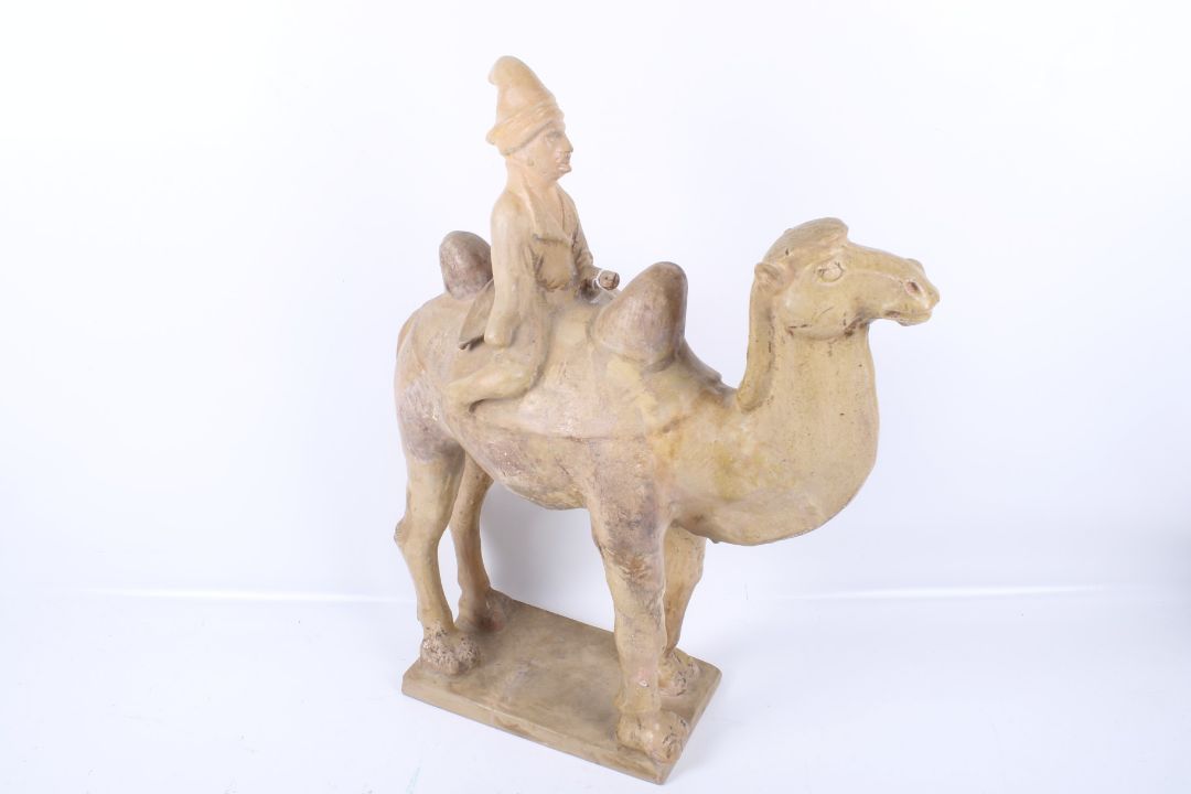 A large Chinese Tang Dynasty earthenware camel and rider. - Image 1 of 5
