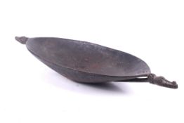 Papua New Guinea. A Sepik River large carved wood canoe shaped bowl.