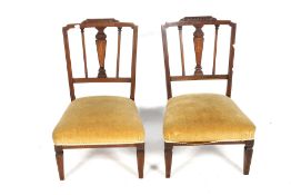 A pair of Edwardian chairs.