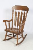 A contemporary Windsor style slat-back rocking chair.
