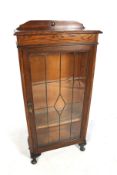 A 20th century oak display cabinet.