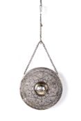 A Persian gong, probably silver. Engraved with scrolling vines and flowers, marked H.