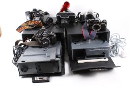 Two Kodak carousel slide projectors and a box of SLR film cameras.