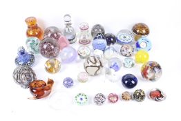 A large collection of vintage and contemporary glass paperweights and inkwells.