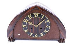 An Art Deco rosewood and mahogany cased arched mantel clock. Eight day mechanism no.