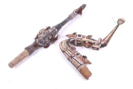 Papua New Guinea. A Humboldt Bay Walamo canoe prow and a Sepik River example.