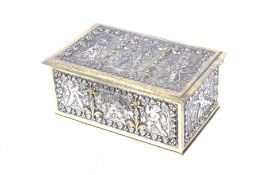 A Japanese gilt metal and brass box. Heavily decorated with cherubs. H6.