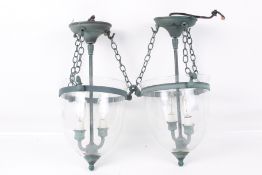 A pair of contemporary glass and copper hall lanterns.