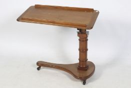A Victorian walnut over the bed reading table.