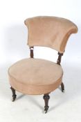 An Edwardian walnut framed nursing chair.
