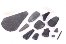 Papua New Guinea. A group of green and black stone axe heads. The largest L30cm.