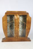 An Art Deco walnut display cabinet.