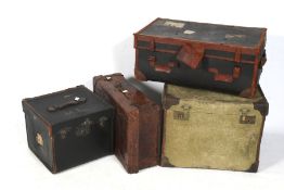 Four vintage suitcases and luggage trunk.