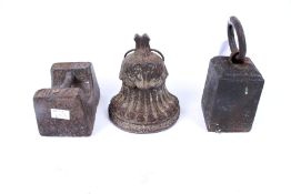 A Victorian cast metal doorstop and two 7Ib weights. The doorstop shaped as a fluted bell.
