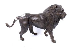 A contemporary bronze figure of a standing lion. Unmarked.