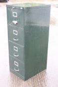 A green metal five door filing cabinet.