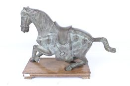 A large bronze Chinese style horse. In a prancing position, mounted on a wooden stand, unmarked.