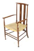 An Arts and Crafts beech elbow chair.