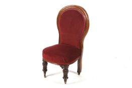 A turn of the century upholstered balloon back chair. Carved front legs with brass casters.