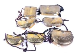 A set of seven Kuwaiti brass purses / containers.