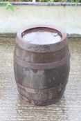A metal banded oak barrel. Appears untapped, stamped 'Heavitree Bay Ltd, Exeter' to the lid, H53cm.