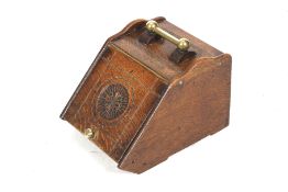 A Victorian carved oak coal scuttle. With brass fittings and a carving to the front.