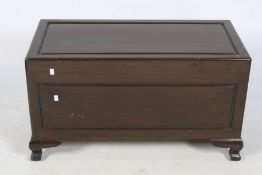 A camphor wood trunk. Having a panelled top and sides, raised on bracket feet, H52cm x W94cm x D45.