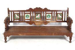 An Indian hardwood bench with reversible tiled back.