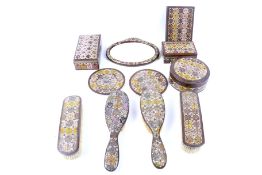 An early 20th century nine piece Indian painted brass dressing table set.