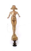 A gold plated cast metal car mascot in the form of a woman. Reg./Ed 656502.