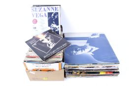 A collection of LP vinyl records and box of 7