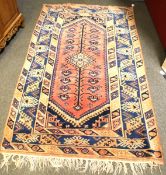 A Persian red ground rug.