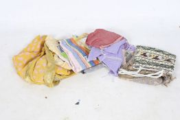 An assortment of Indian Sari fabric and a beaded bag.