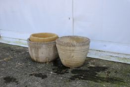 Three stone circular garden pots.