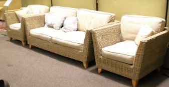 A contemporary rattan three piece sofa suite.