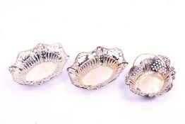A pair of pierced small silver dishes and a small basket.