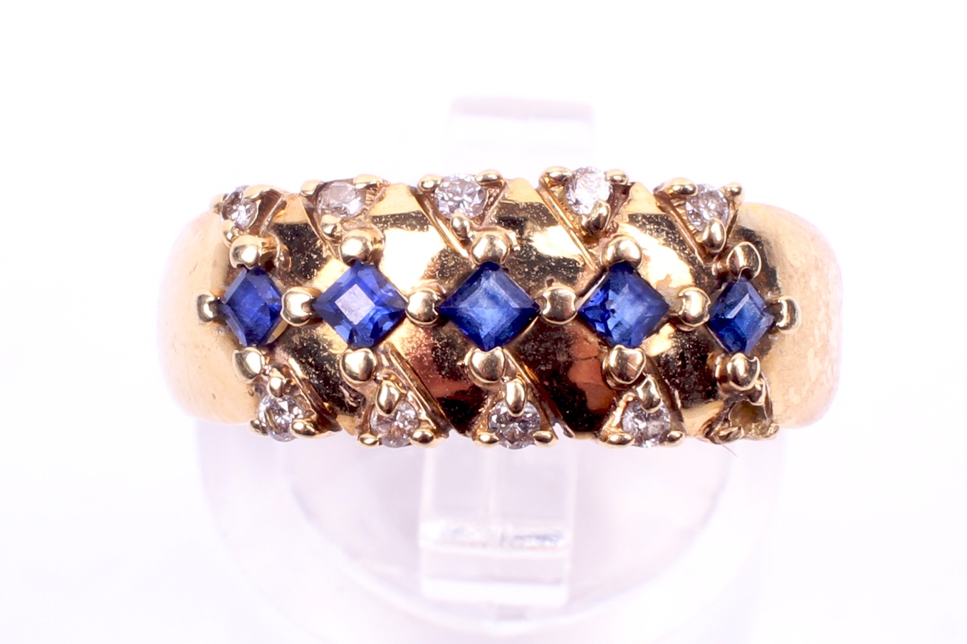 A yellow metal sapphire and diamond set dress ring. Five trap cut sapphires of 0. - Image 2 of 4