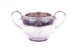 A silver twin handled sugar bowl.