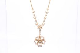 An Edwardian gold, half pearl and diamond pendant and chain.