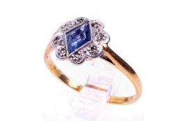 A yellow metal ring set with blue and white stones.